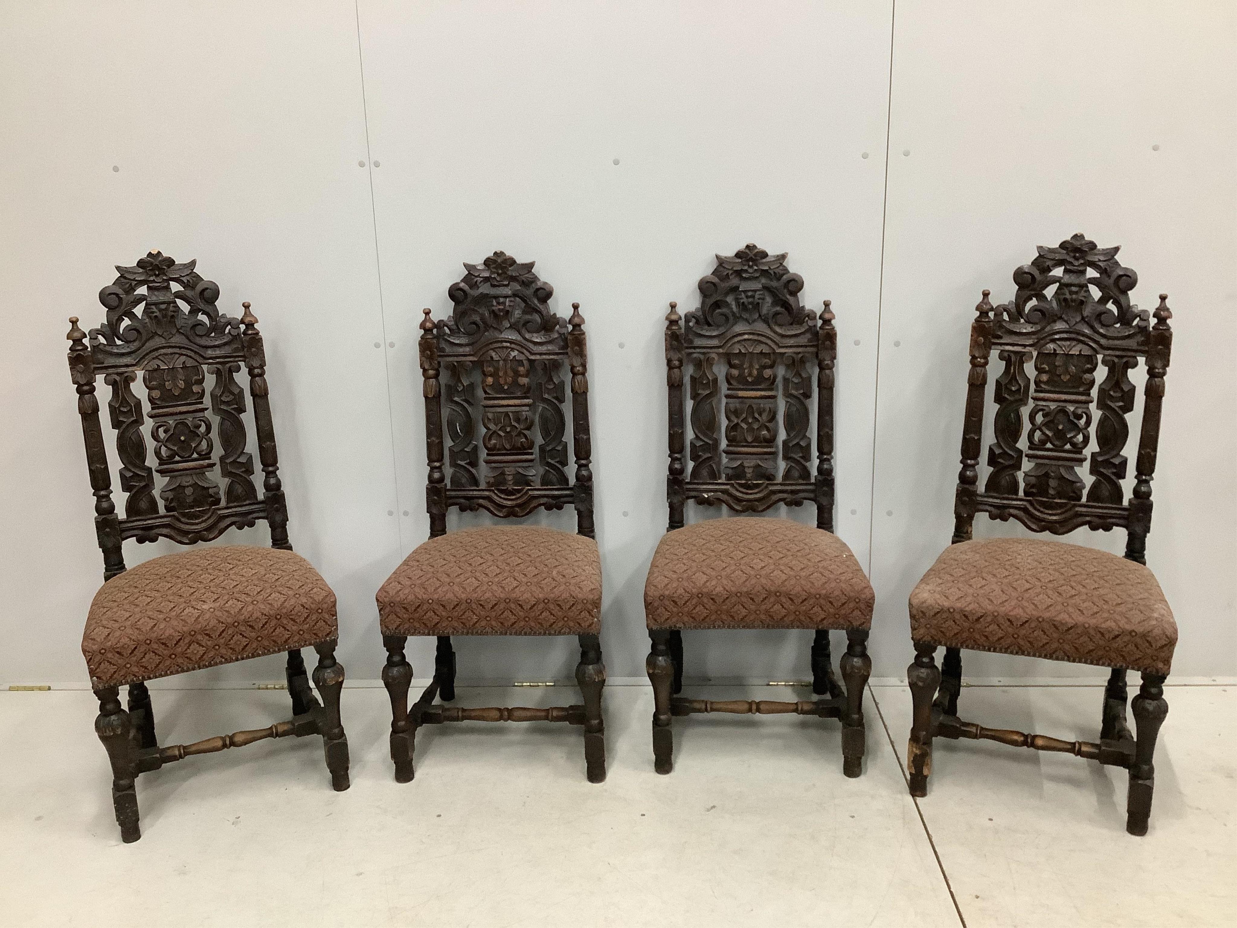 A set of thirteen carved Victorian oak dining chairs, one with arms. Condition - poor to fair